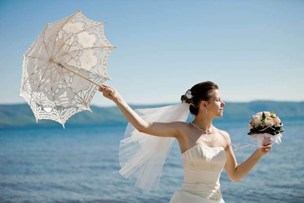 Невеста с букетом роз, с тонкой летящей фатой в волосах, держит в руке белый кружевной зонтик  - фото 3037697 Фотограф Екатерина Ольгина